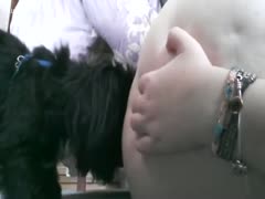 Black dog eating fattie up